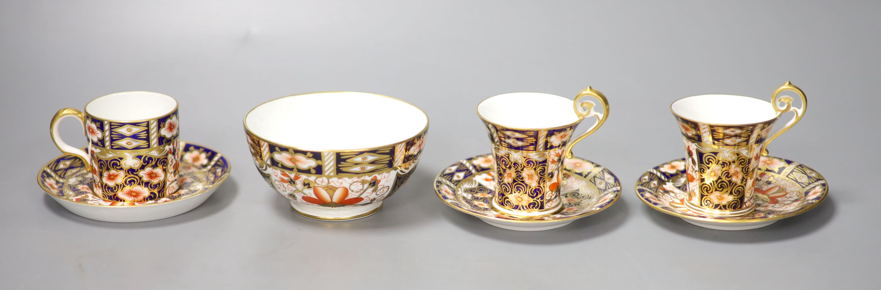 A pair of Royal Crown Derby coffee cups, imari pattern 2451, a coffee can and saucer and a sugar bowl